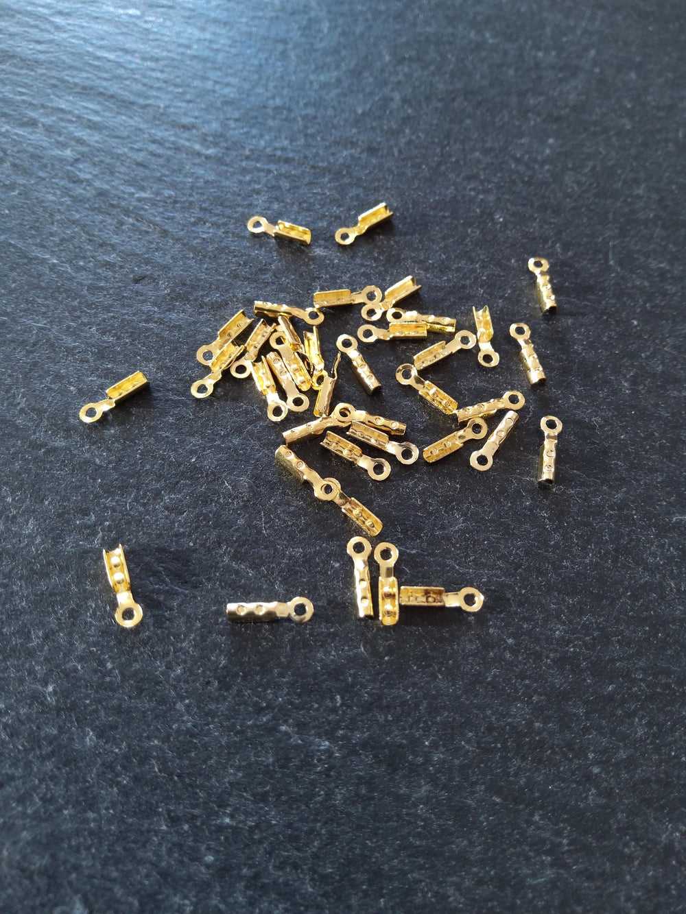 60 or 300 Gold Plated Brass Folding Crimp Ends 7.5x2.5mm For 1mm Cord. Hole: 1mm
